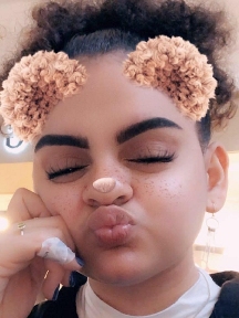 Mya in 2017 with rainbow makeup at her first Pride Parade